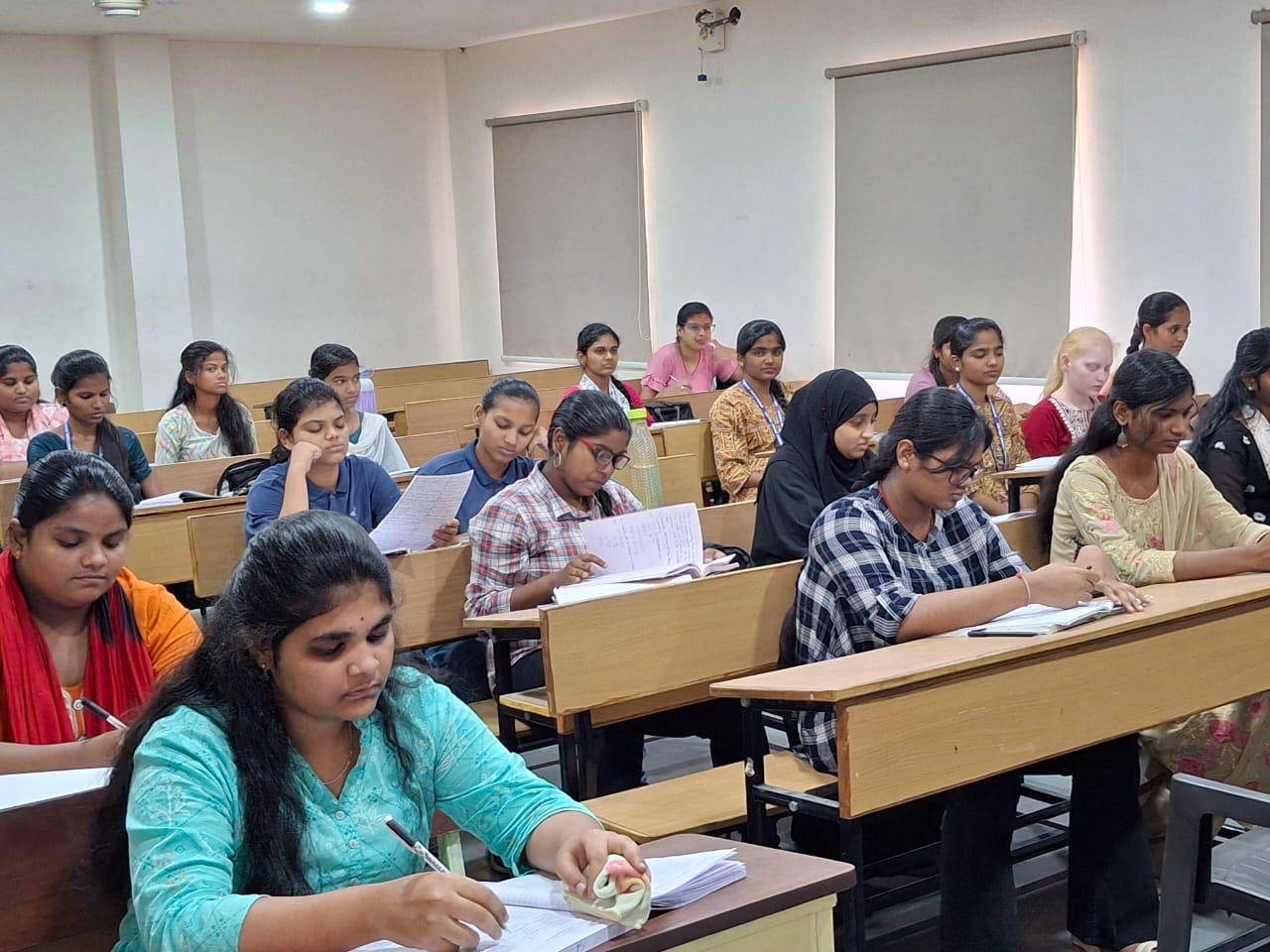 Students in an IJD College classroom in Shaikpet writing during a morning class