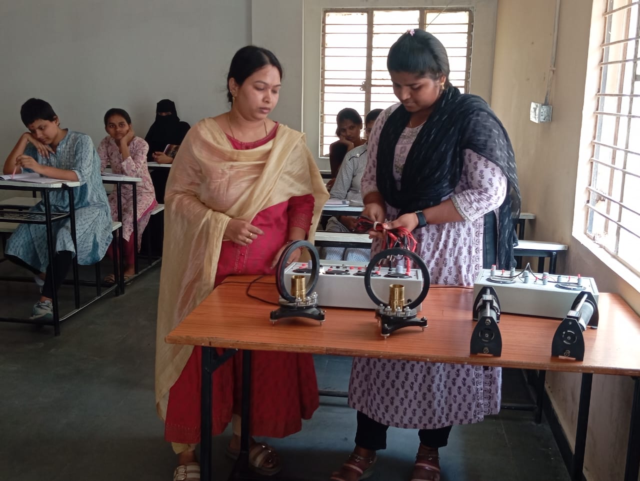 Physics laboratory at IJD College with apparatus, faculty and students